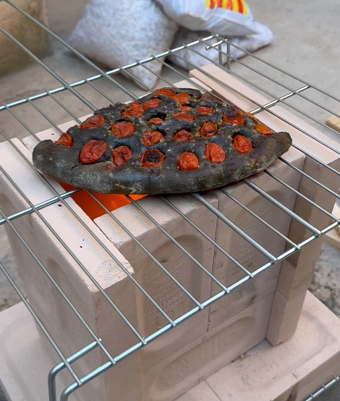 simple brick rocket stove baking a focaccia